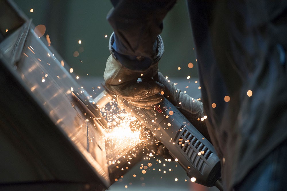 ALMCO Fabrication Specialist grinding on new equipment.