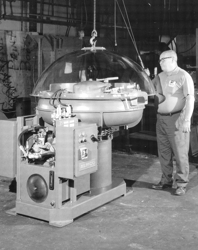Operator lowering the lid onto a vibratory bowl