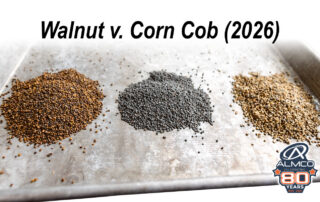 A stainless steel tray has piles of walnut and corn cob finishing media from ALMCO