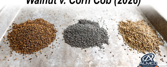 A stainless steel tray has piles of walnut and corn cob finishing media from ALMCO