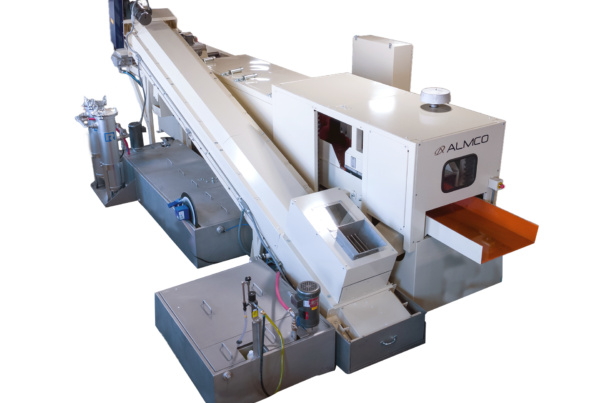 The back of a thru-feed vibratory tub system with additional sound dampening features.